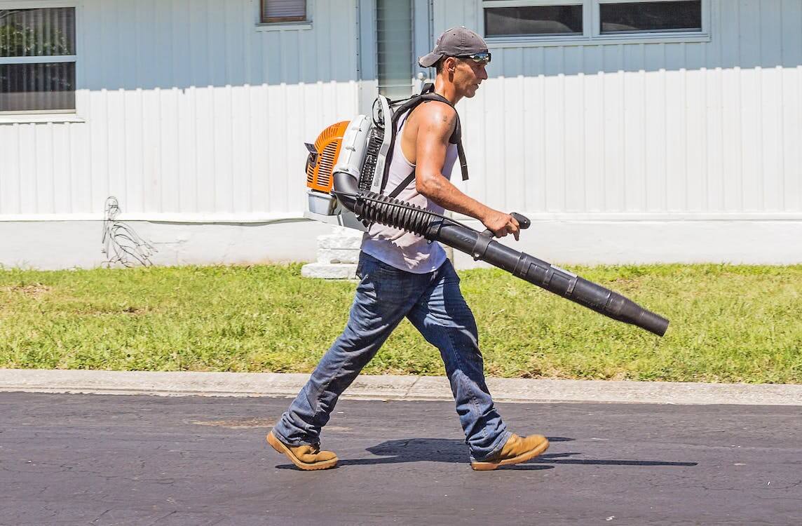 man walking with gas leaf blower