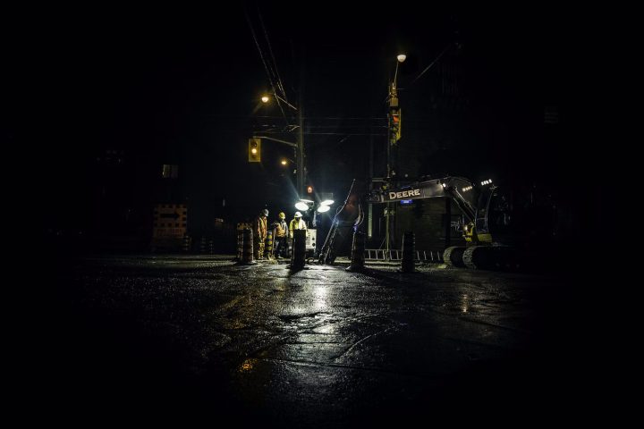 construction workers doing road work at night