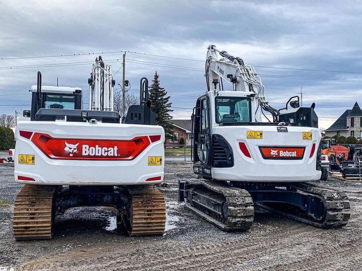 up-close view of treads and cab on 2 different sized Bobcat excavators